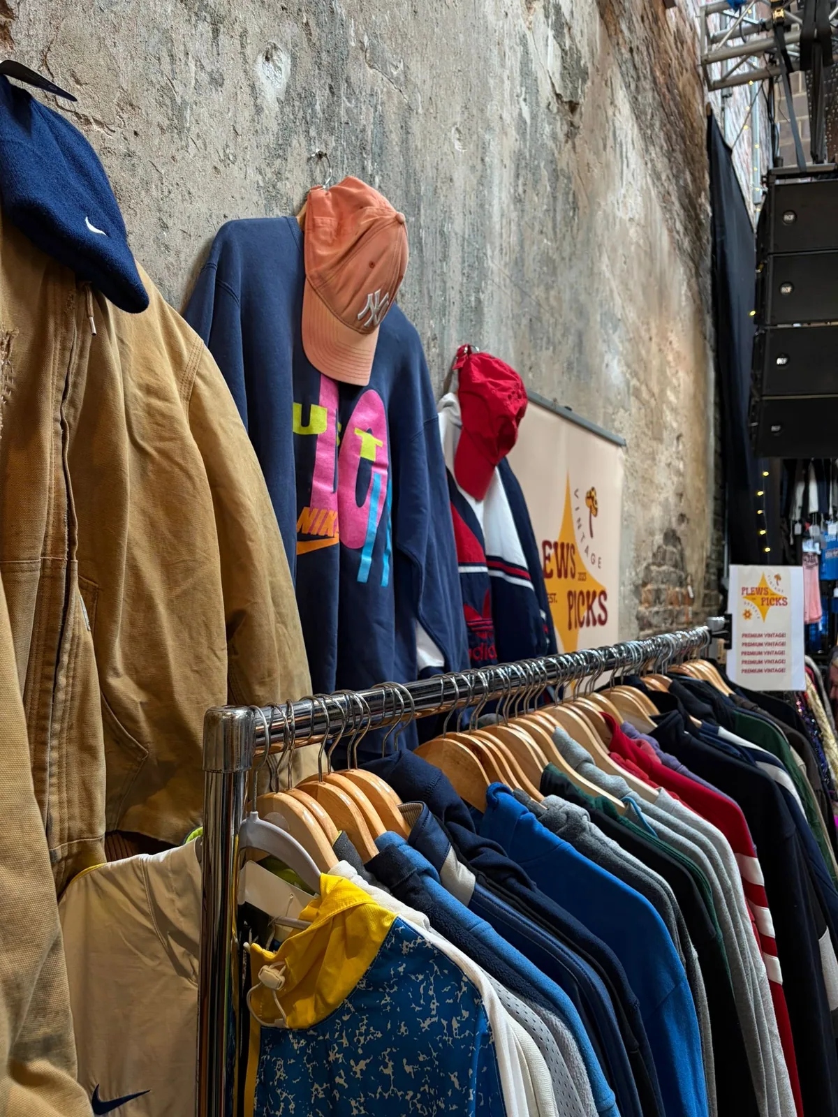 Vintage sportswear and clothing displayed at a market stall